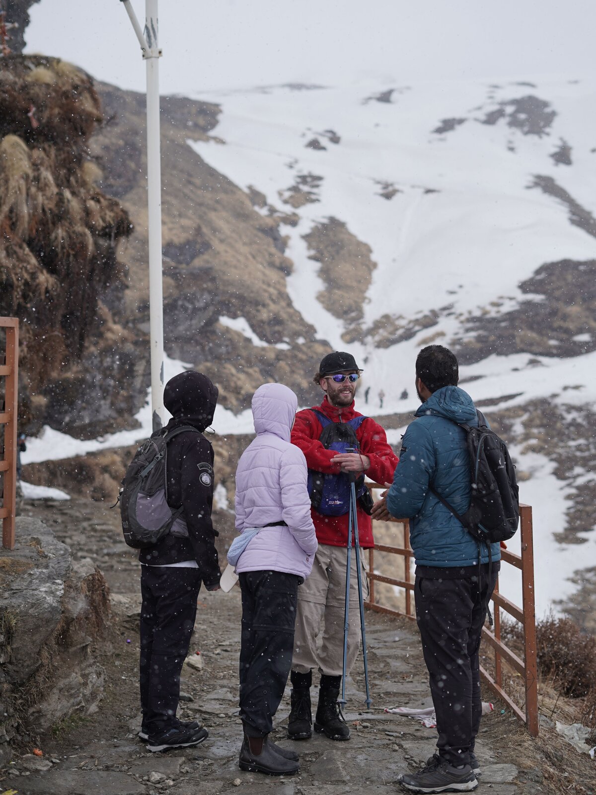 Trekkers hiking through snow in Uttarakhand
