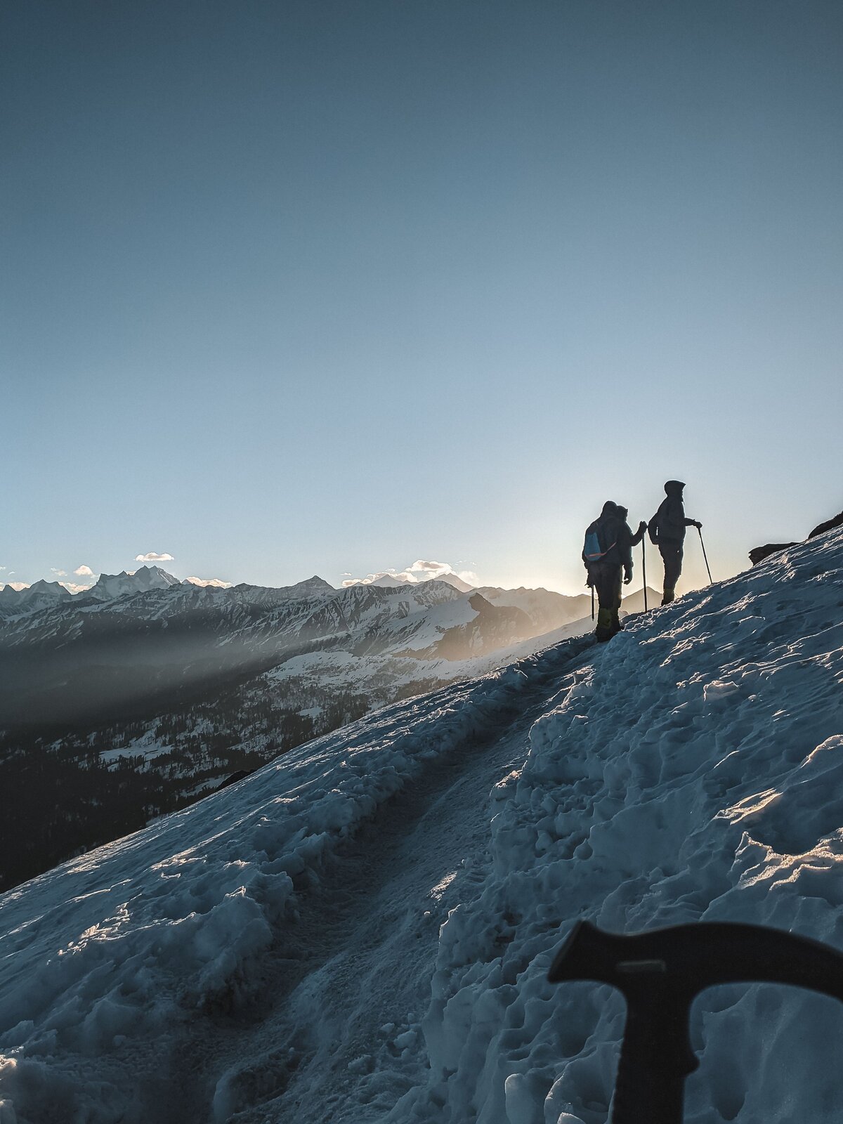 Trekkers on the summit ridge at sunset