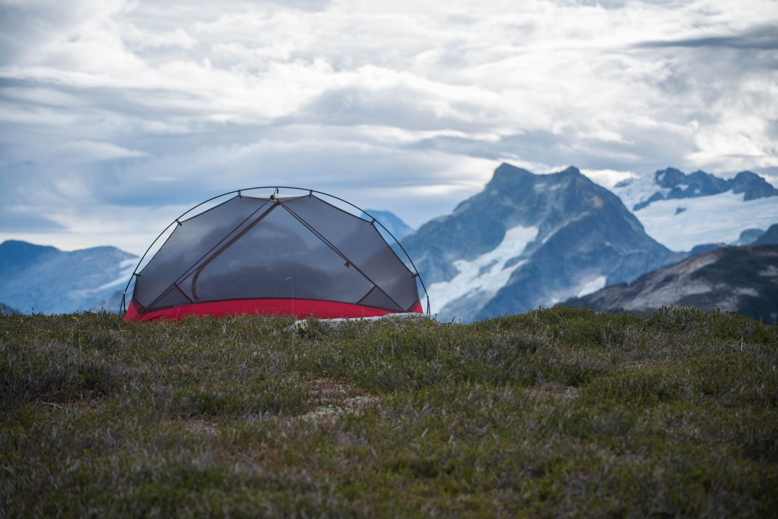 Camp tent set against a mountain backdrop